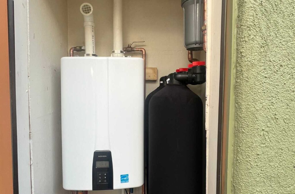 A TAZ Plumbing expert showcasing high-quality water heaters in Vail, AZ.